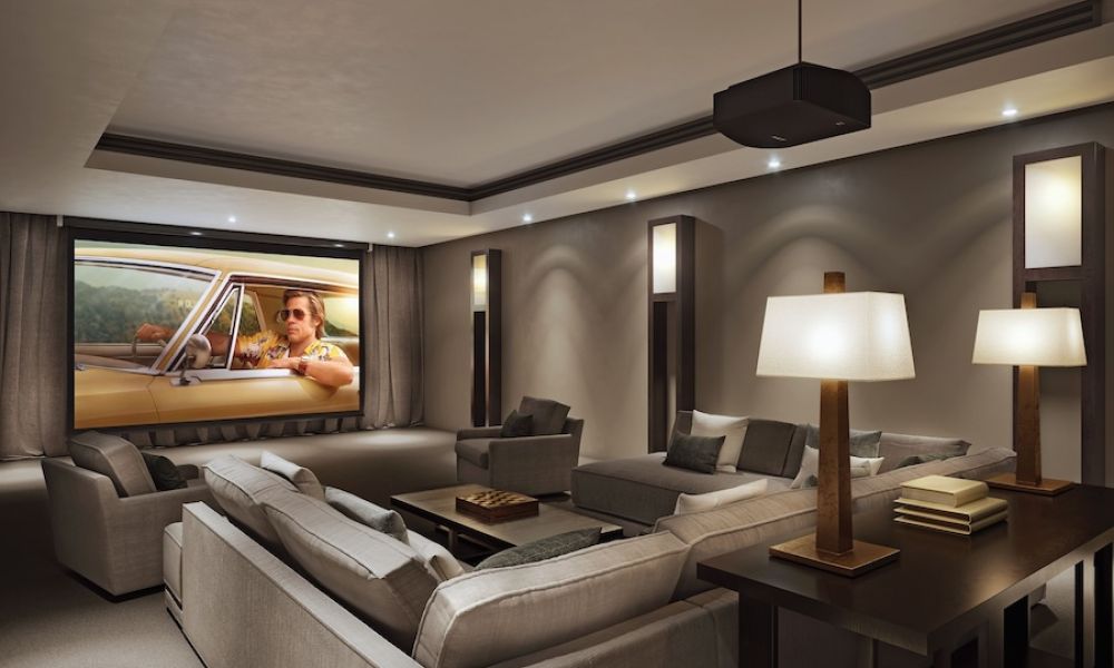 <span class="uk-h4">Luxurious home theater with cozy gray sectional seating, ambient lighting, and a large projector screen showing a movie.</span>